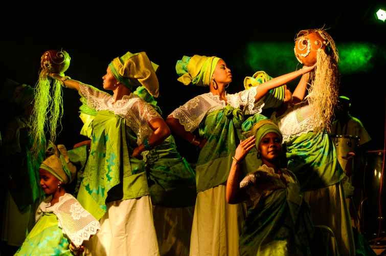 group of women wearing green and white dresses