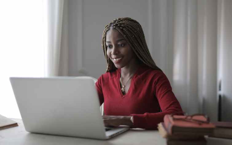 woman in red long sleeve shirt using macbook
