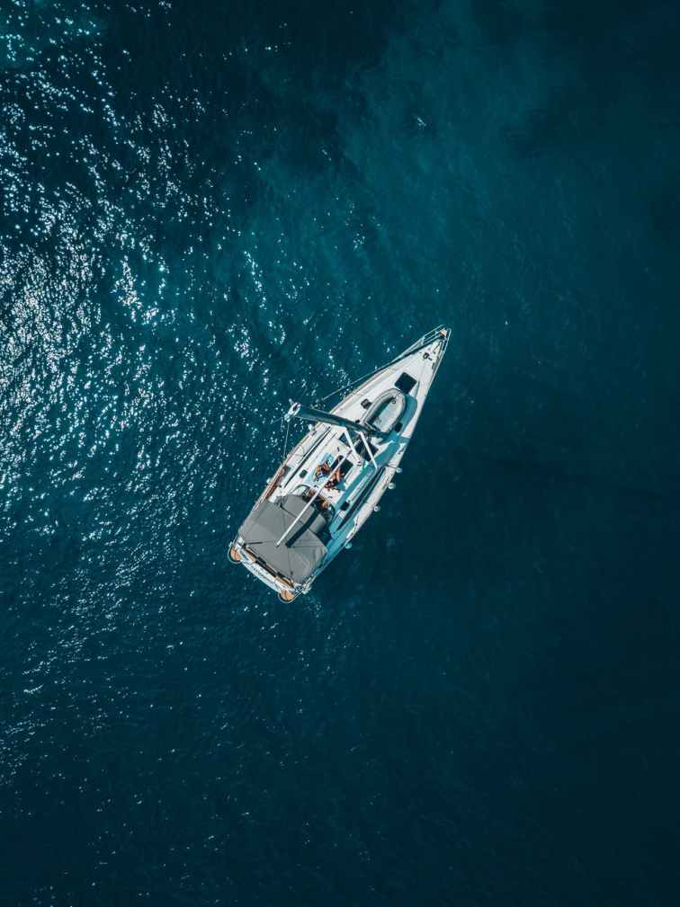 high angle photo of white boat on body of water
